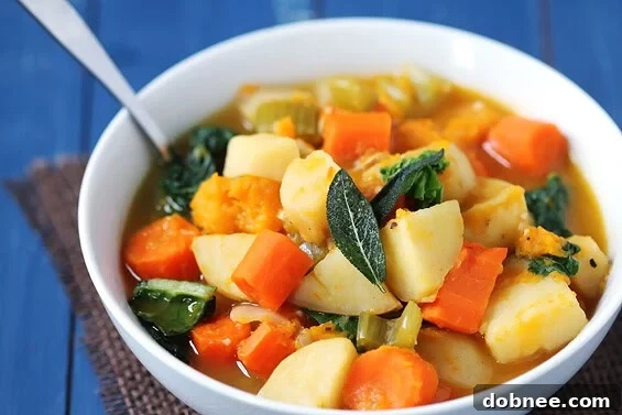 Hearty slow cooker root vegetable stew, brimming with colorful vegetables like butternut squash and kale.