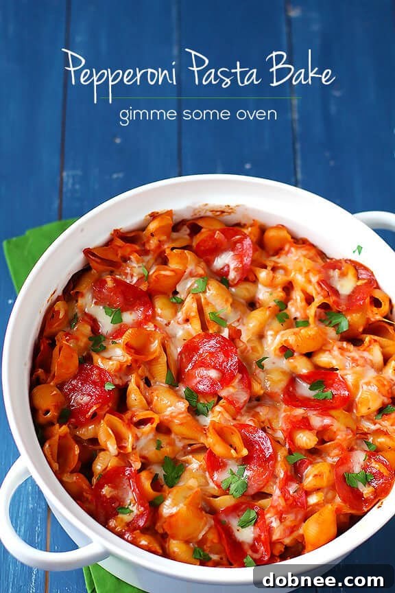 A large baking dish filled with a golden brown Pepperoni Pasta Bake, garnished with fresh herbs, ready for serving.
