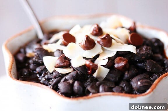 Velvet Black Bean Chili With Chocolate and Coconut 5 A bowl of rich Black Bean Chili, ready to be enjoyed, garnished with chocolate and coconut