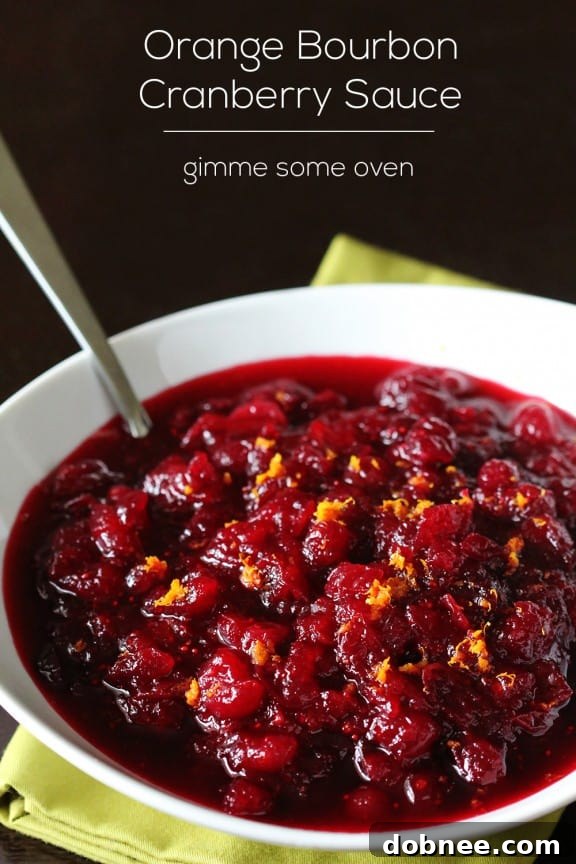 A festive holiday spread featuring roasted turkey, various side dishes, and a prominent bowl of Orange Bourbon Cranberry Sauce, ready for a feast.
