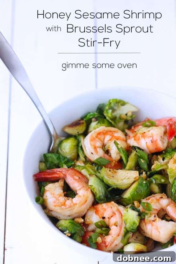 Close-up shot of a prepared Honey Sesame Shrimp and Brussels Sprouts Stir Fry, showcasing the vibrant colors and textures.