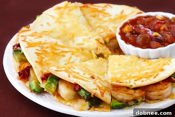 Unique Parmesan-Crusted Shrimp Quesadillas with avocado and sun-dried tomatoes.