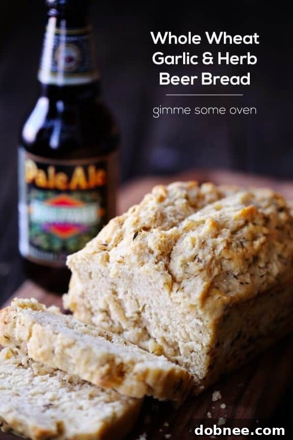 A final close-up shot of the perfectly baked Whole Wheat Garlic & Herb Beer Bread loaf.