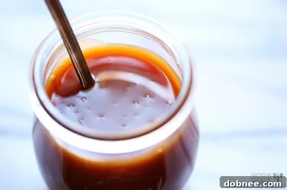 Homemade microwave caramel sauce in a glass measuring cup, ready to be served