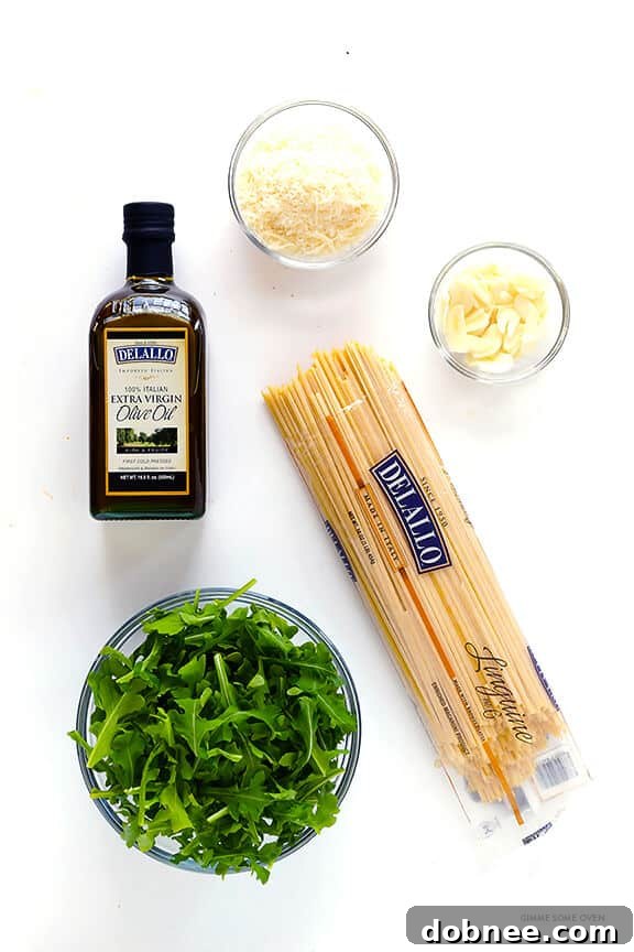 Key ingredients for Linguine with Arugula, Garlic, and Parmesan including pasta, arugula, garlic, and Parmesan cheese