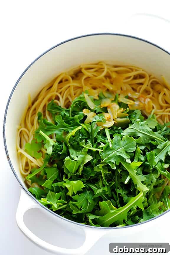 Cooking process of Linguine with Arugula, Garlic, and Parmesan, showing garlic being sautéed