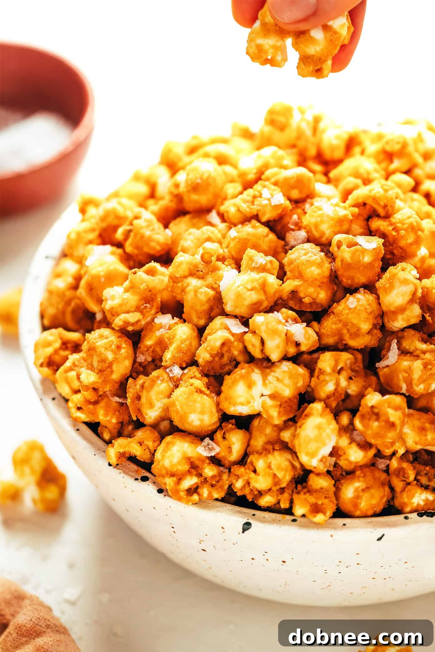 A bowl overflowing with freshly made homemade caramel corn.