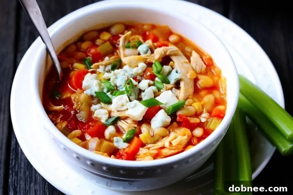 Delicious Buffalo Chicken Chili topped with blue cheese crumbles and fresh green onions