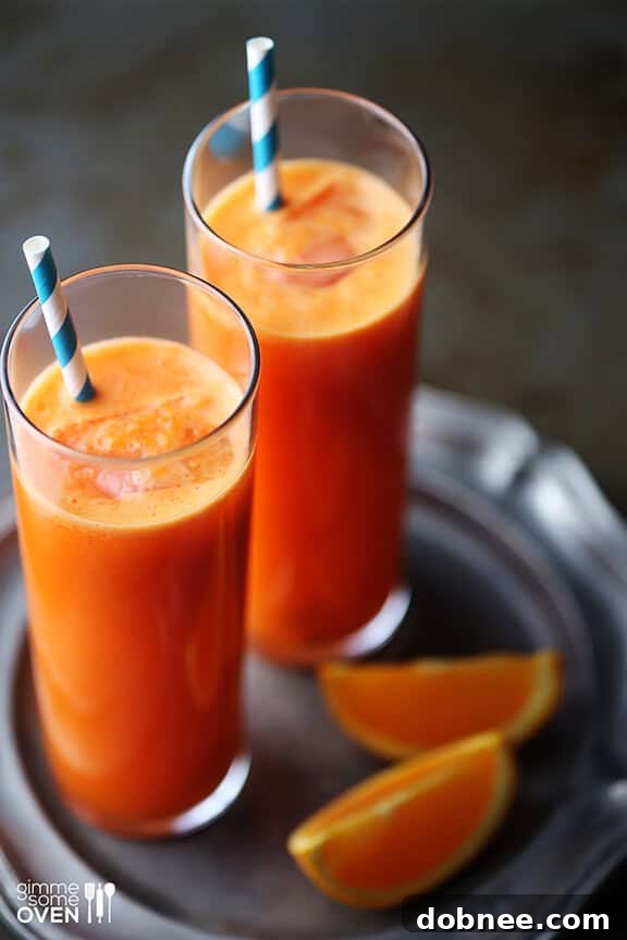 Glass of vibrant Orange Carrot Ginger Juice