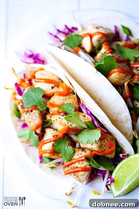Close-up of an assembled Thai Chicken Taco, showing the rich peanut sauce and fresh herbs