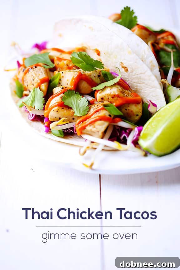 A plate of freshly made Thai Chicken Tacos, garnished with cilantro and lime wedges