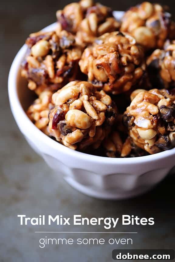A bowl of Trail Mix Energy Bites with ingredients in the background