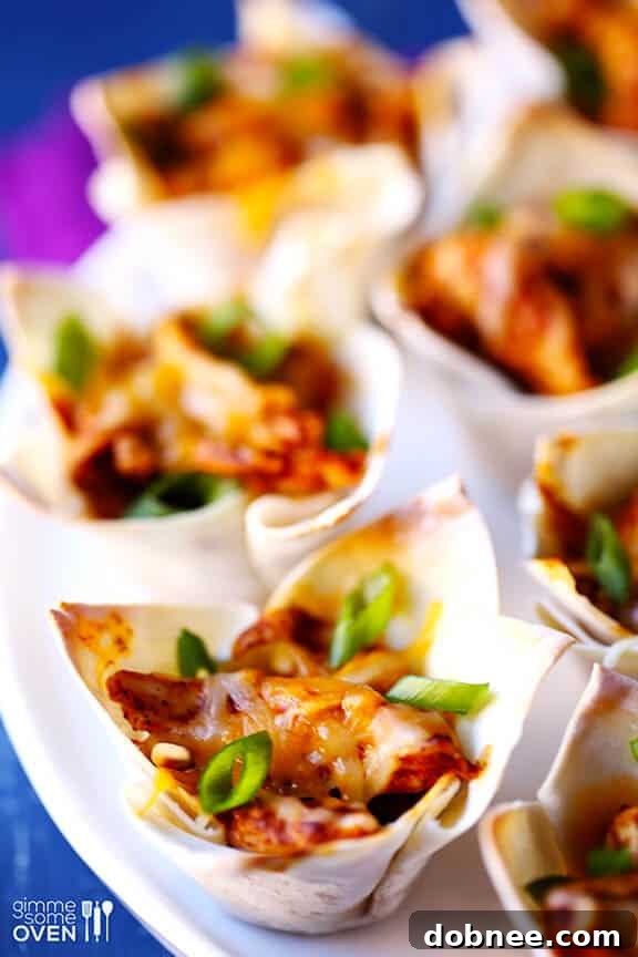 Close-up of golden brown chicken enchilada cups in a muffin pan