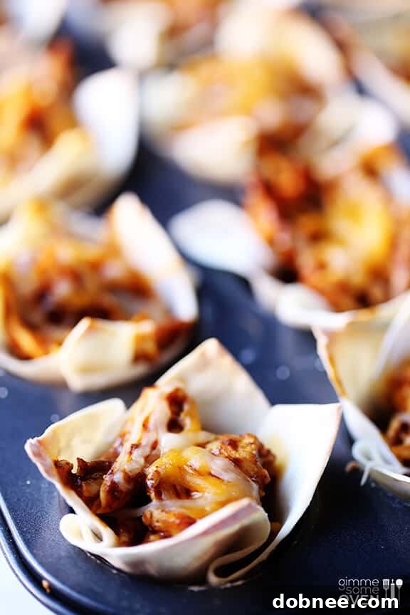 Freshly baked chicken enchilada cups garnished with sliced green onions