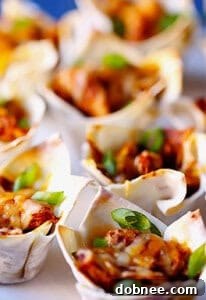 A plate full of golden chicken enchilada cups