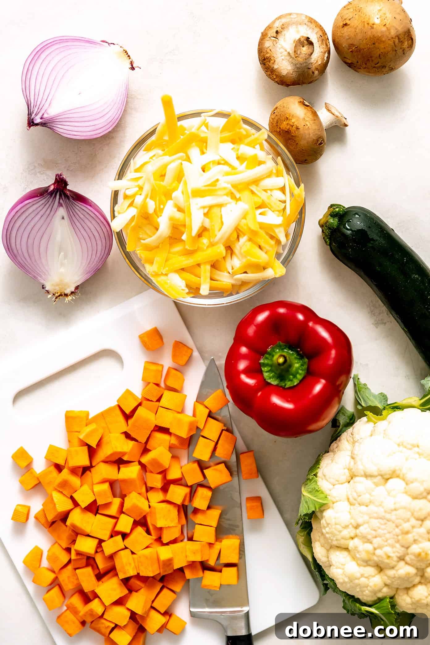 This Tex-Mex-inspired roasted vegetable enchiladas recipe is easy to customize with your choice of veggies, beans, cheese. Always a delicious vegetarian dinner recipe! | gimmesomeoven.com Ingredients for Roasted Vegetable Enchiladas laid out on a board