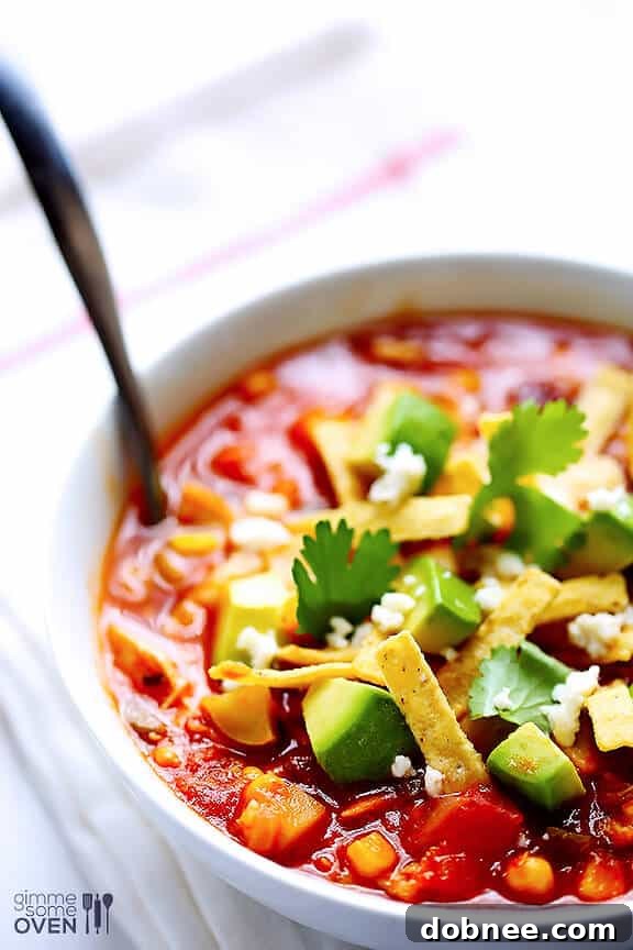 Close-up of a rustic bowl of Chipotle Chicken and Rice Soup, vibrant and inviting for a cozy meal