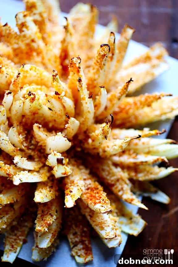 Close-up of a perfectly baked blooming onion, golden brown and crispy.