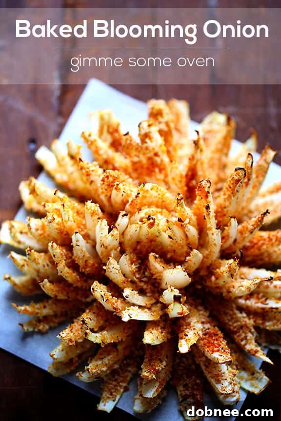 Baked blooming onion on a serving platter with dipping sauce