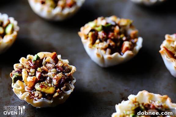Delicious Baklava Cups arranged on a serving plate, drizzled with honey