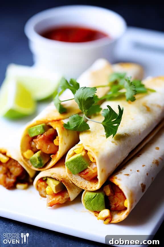 A close-up shot of golden-brown baked taquitos filled with shrimp, avocado, and roasted corn, showcasing their crispy texture.