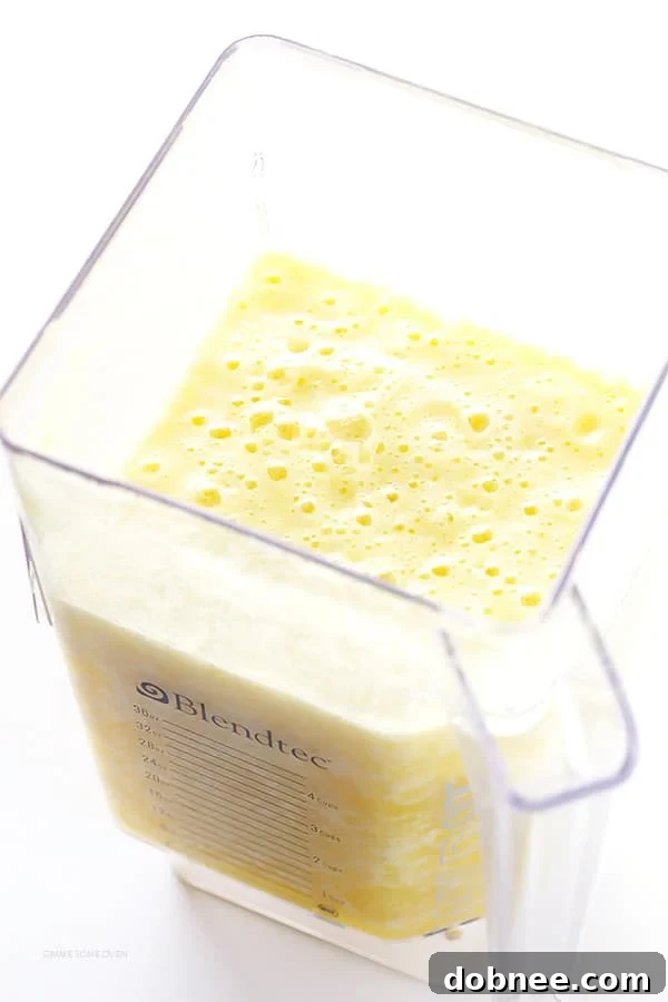 Tropical Pineapple Margaritas 5 Pouring Fresh Pineapple Margaritas into salt-rimmed glasses