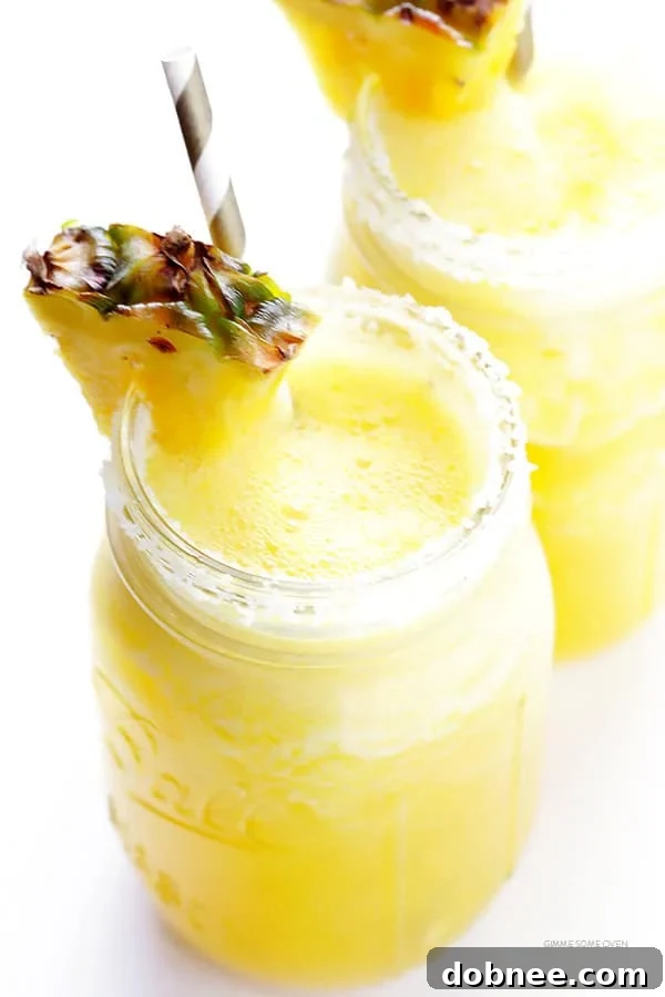 Tropical Pineapple Margaritas 7 Two Fresh Pineapple Margaritas garnished with lime and pineapple
