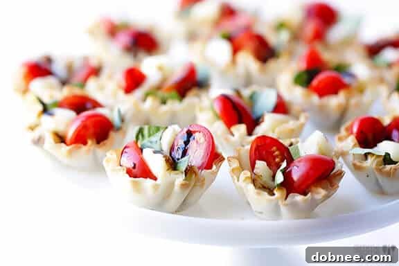 Hands arranging ingredients into phyllo cups