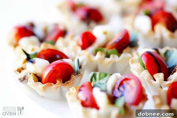A single Caprese Phyllo Cup on a white plate