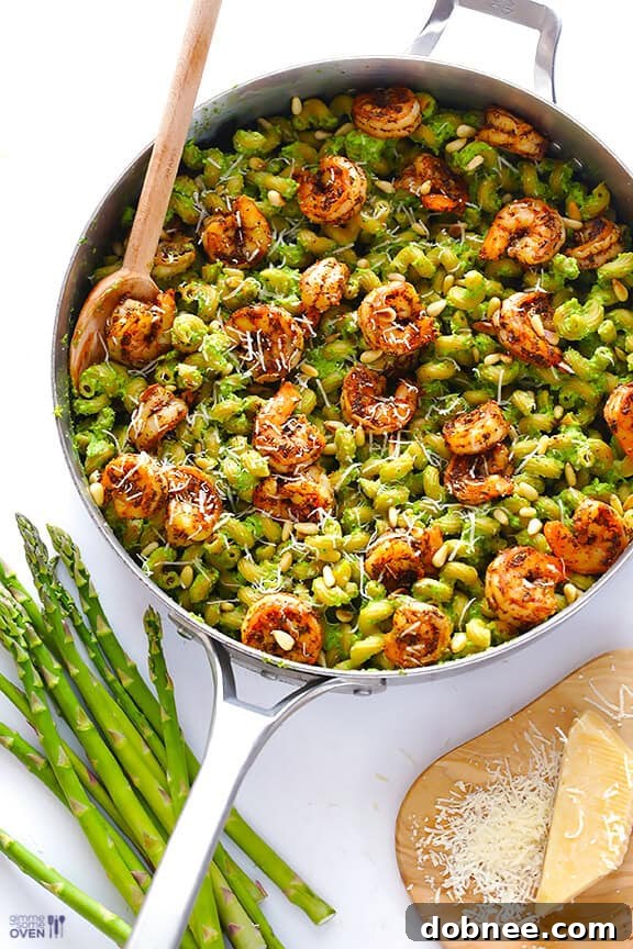 Finished Pesto Pasta with Shrimp Asparagus-Spinach Pesto Pasta with Blackened Shrimp, garnished with Parmesan.