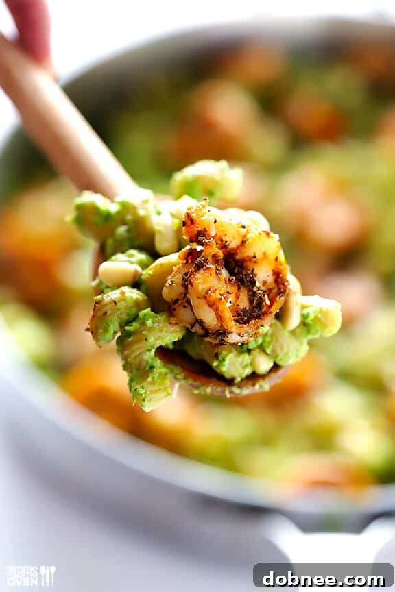 Delicious Pesto Pasta with Blackened Shrimp Bowl of Asparagus-Spinach Pesto Pasta with Blackened Shrimp, ready to eat.