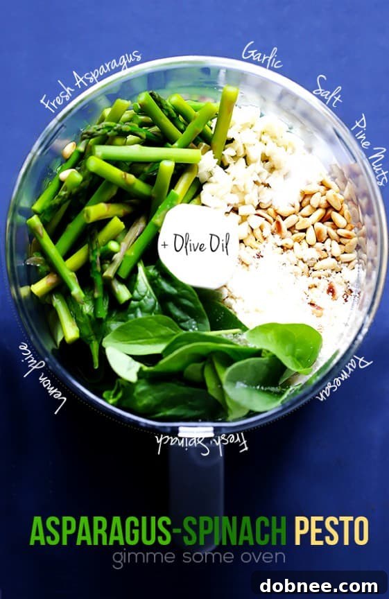 Ingredients for Asparagus Spinach Pesto Bright green asparagus and spinach pesto in a food processor, ready to blend.