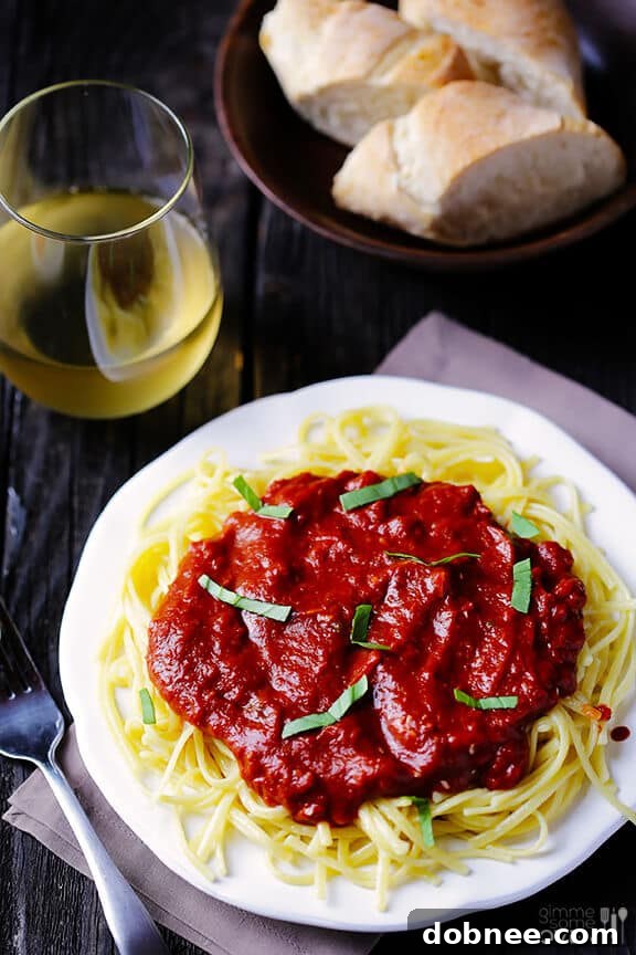 Pasta with Dark Chocolate Marinara Sauce close up showing rich sauce and fresh basil.
