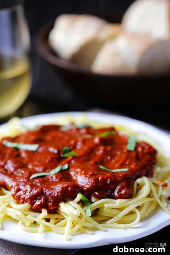 Pasta with Dark Chocolate Marinara Sauce garnished with fresh basil leaves.