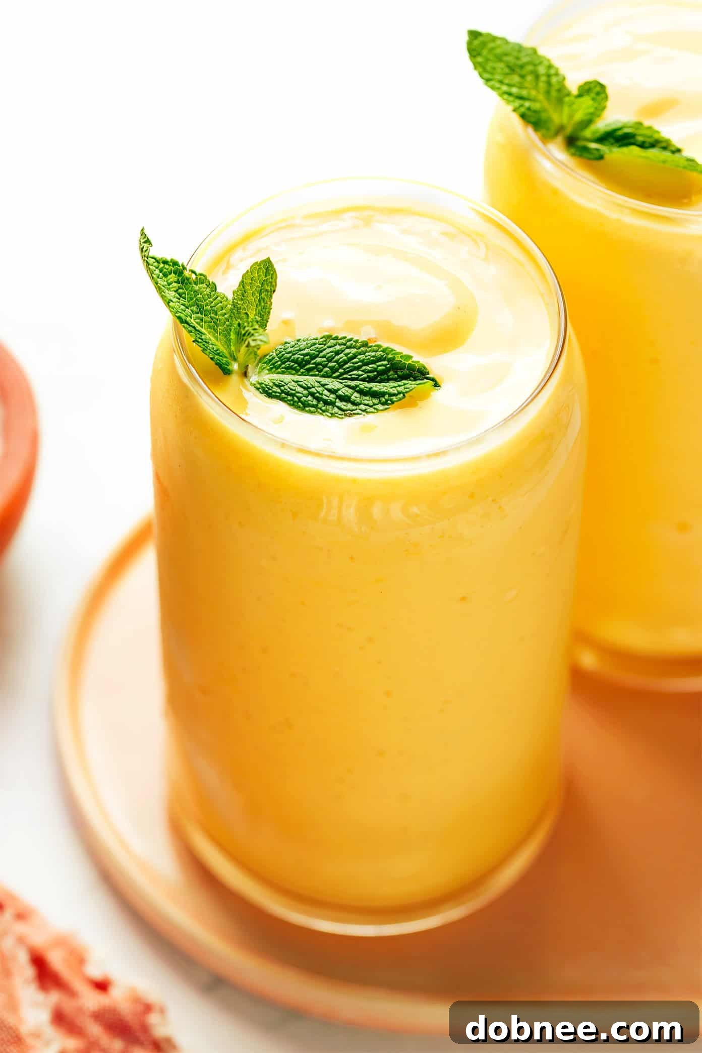 Vibrant mango lassi in a glass, ready to be enjoyed