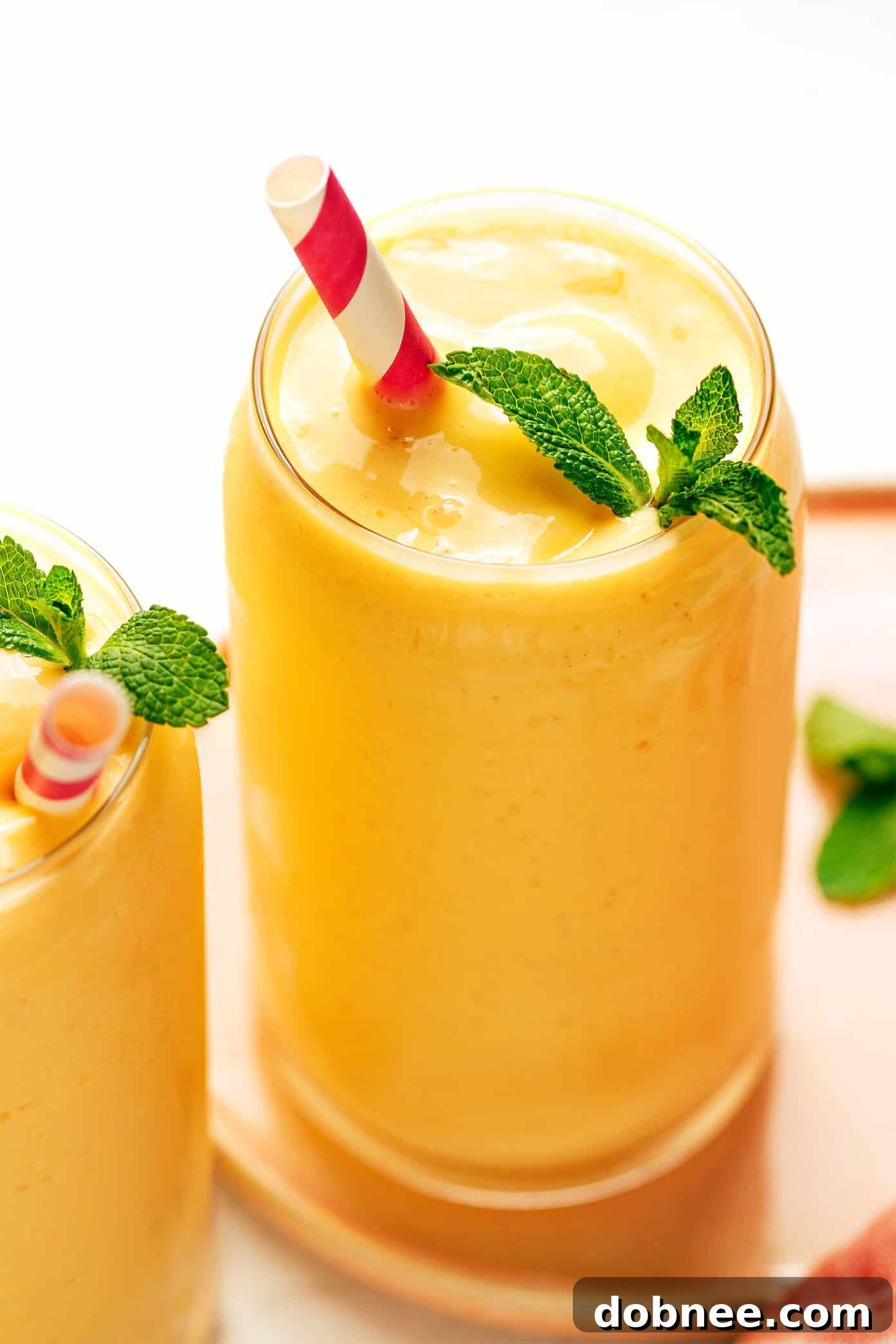 A selection of mango lassi ingredients laid out: mangoes, yogurt, milk, spices