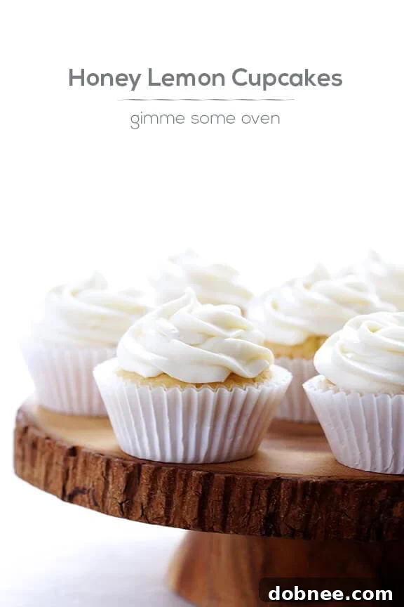 A stack of delicious Honey Lemon Cupcakes with creamy frosting, a perfect dessert.