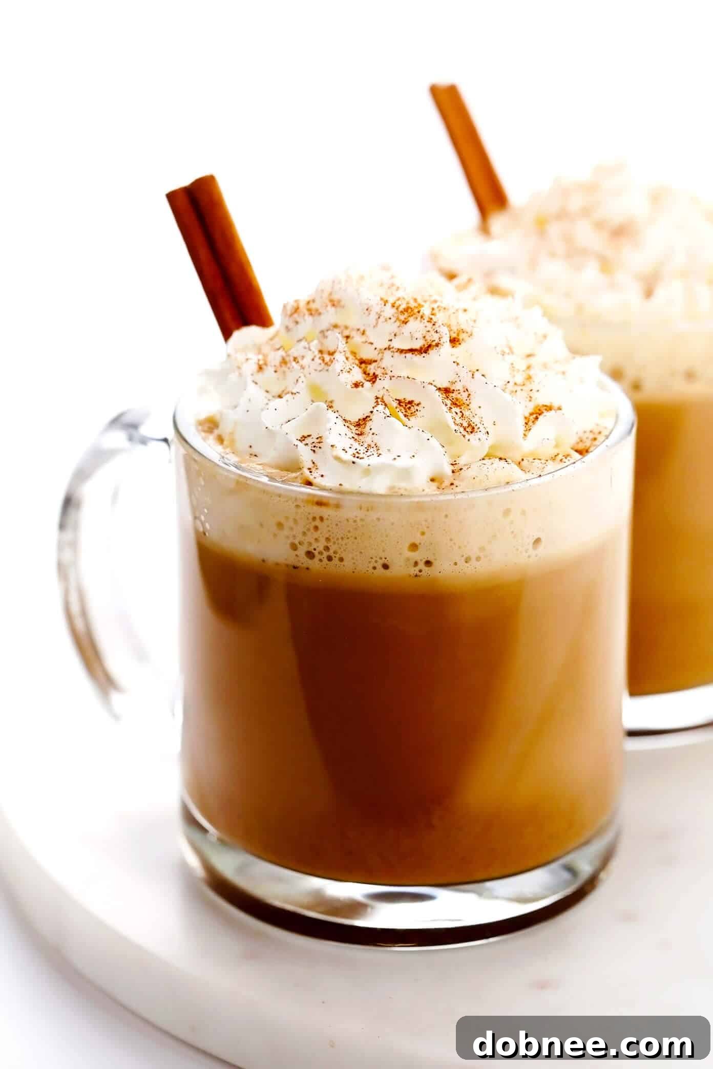 A warm, inviting homemade pumpkin spice latte topped with whipped cream and a sprinkle of pumpkin pie spice, perfect for autumn