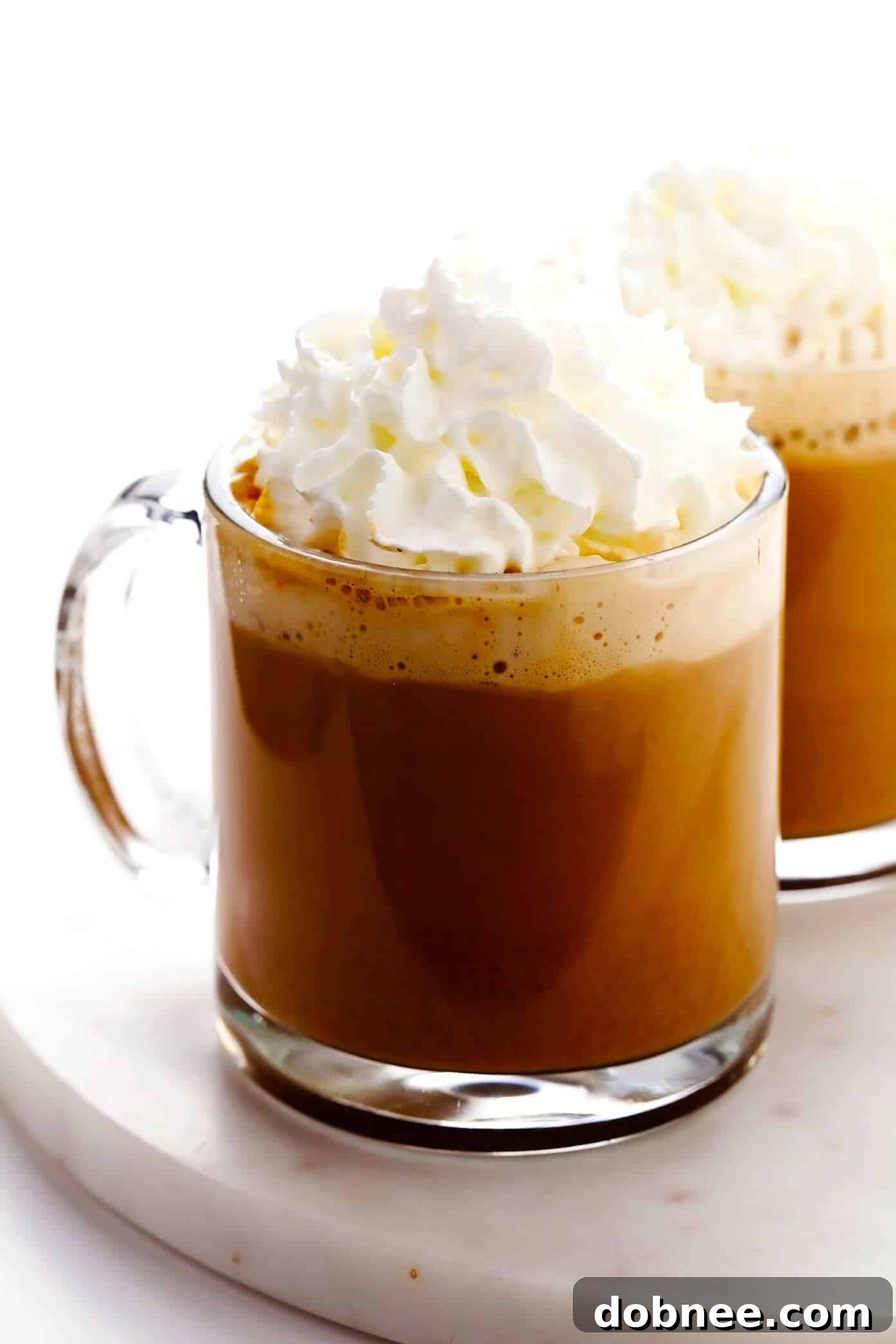 A homemade pumpkin spice latte topped with a generous swirl of whipped cream, ready to be enjoyed
