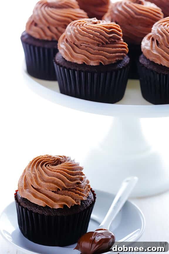 Decadent Nutella Cupcakes 4 Hand Dipping into Nutella Jar