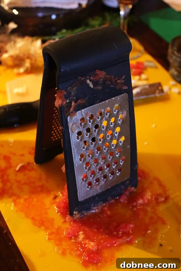 Grating tomatoes for a Spanish sauce