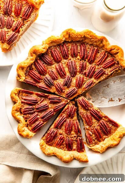 A stunning, golden-brown pecan pie, ready for slicing.