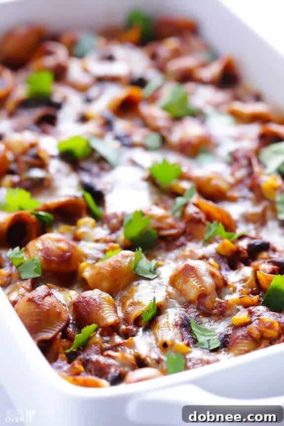 Full baking dish of Chicken Enchilada Pasta Bake, fresh from the oven, bubbling with cheese