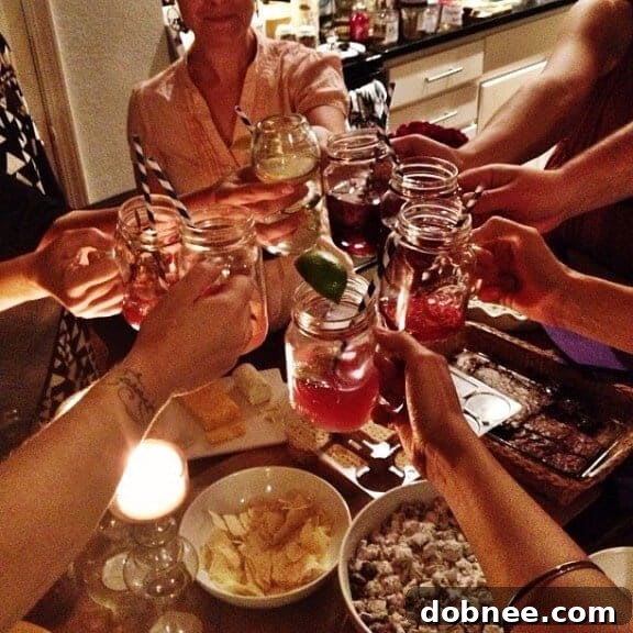 Friends gathered around, enjoying drinks and conversation at the mocktail party.