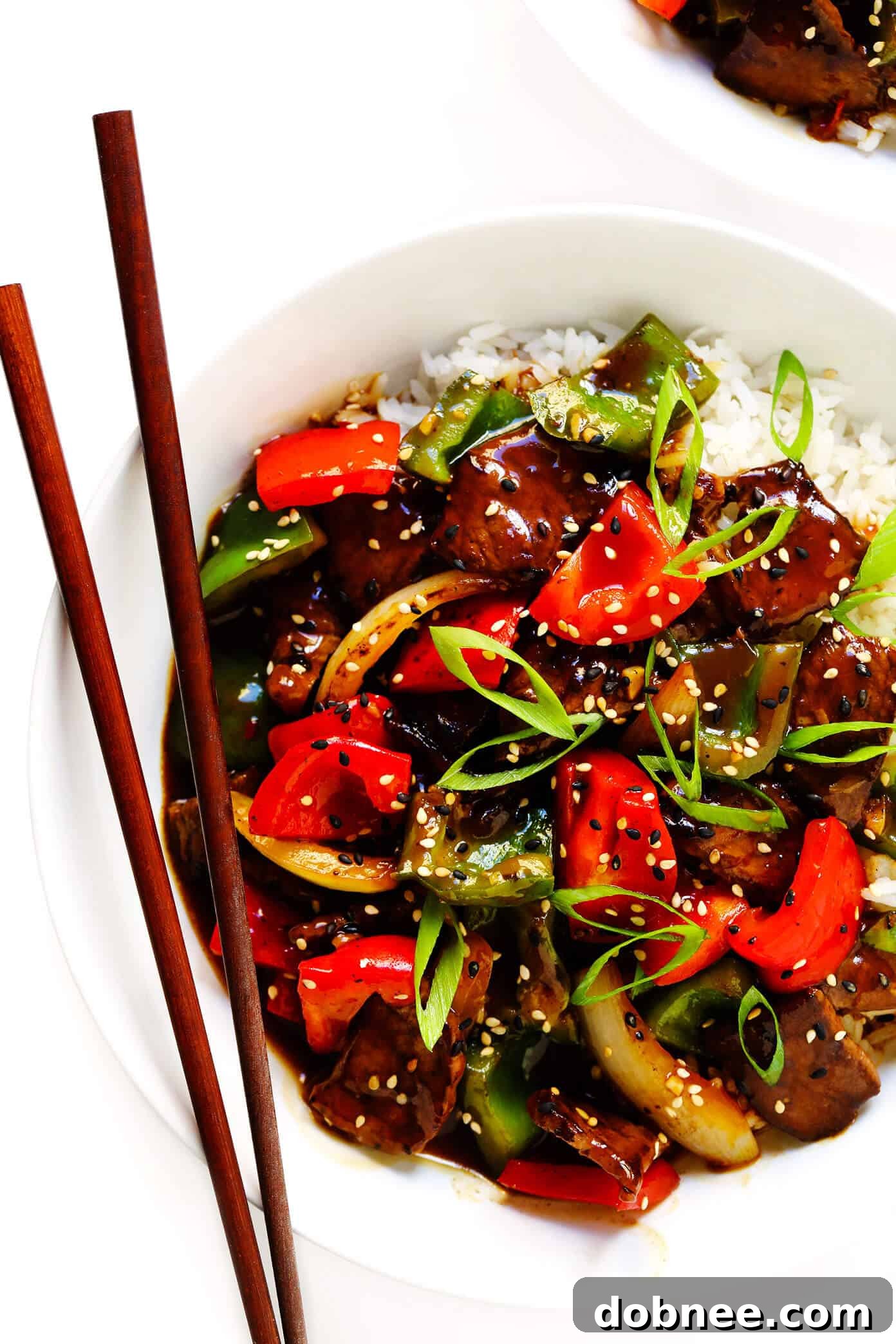 Easy Pepper Steak, vibrant stir-fry with thinly sliced beef and colorful bell peppers over rice.