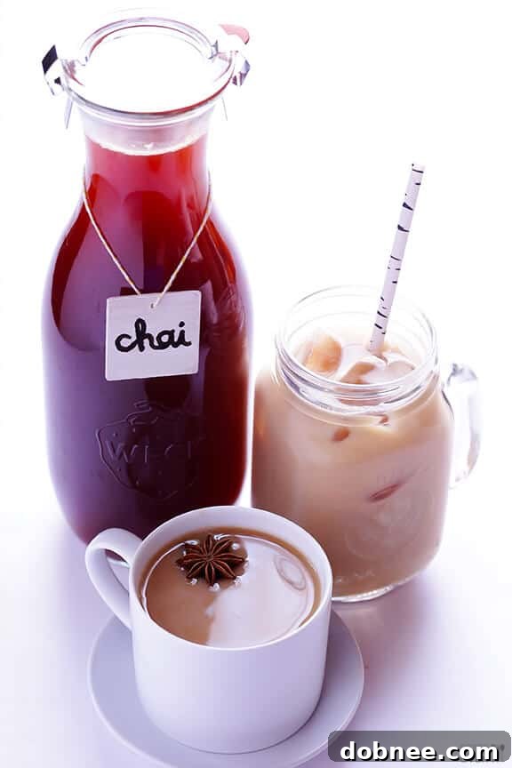 Various whole spices, including cardamom, cinnamon, and ginger, arranged on a wooden board, ready for making chai.