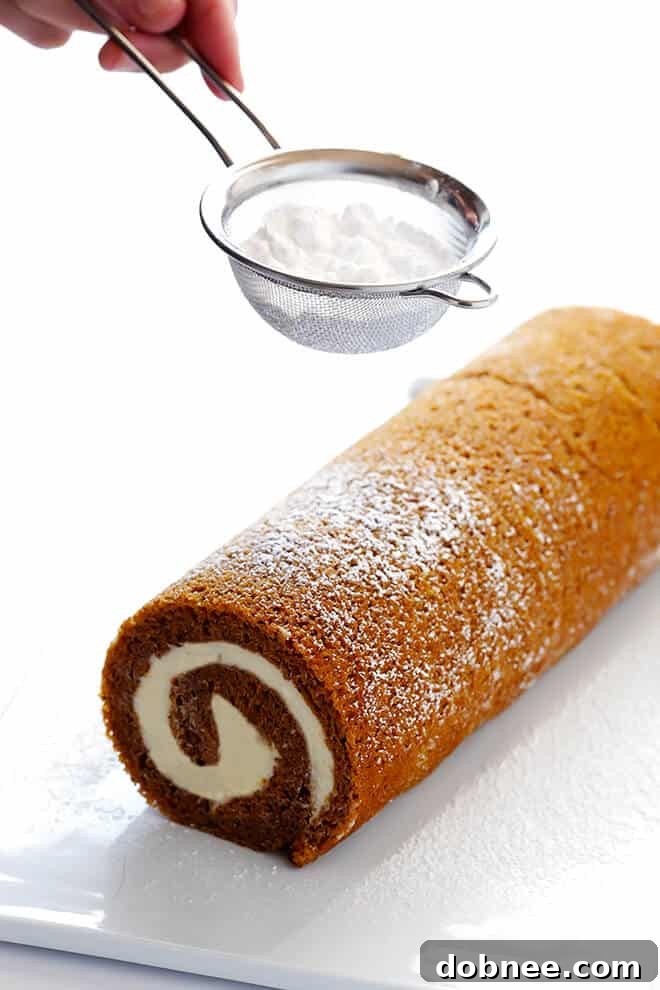 Sprinkling Powdered Sugar On A Pumpkin Roll