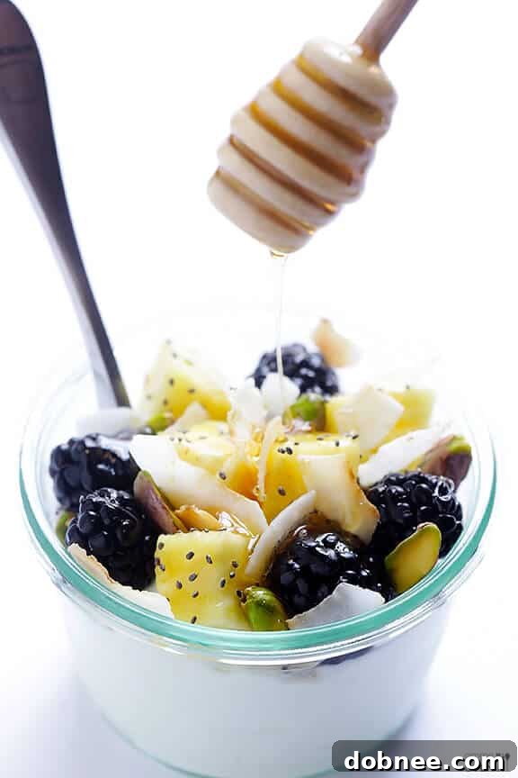 Delicious Greek Yogurt Parfait with fresh fruit, pistachios, and toasted coconut.