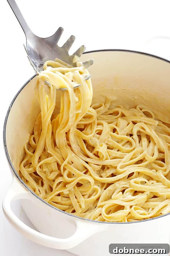 Close-up of freshly tossed skinny fettuccine alfredo, ready to be served.