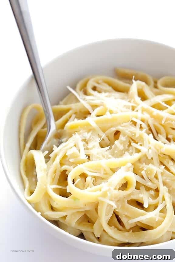 Skinny fettuccine alfredo topped with freshly grated Parmesan cheese and herbs.